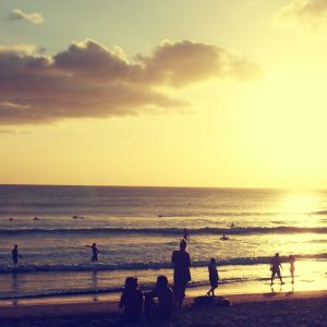 silhouette photography of people standing on shore near sea